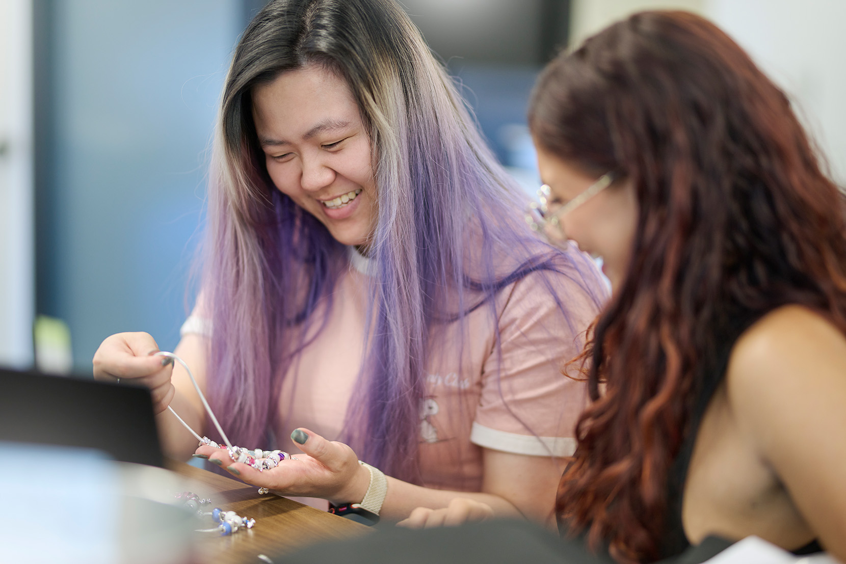 Person assembling charm bracelet